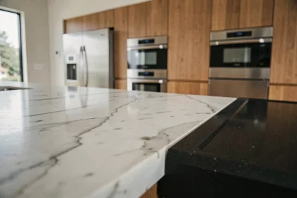 Comptoir de cuisine moderne en marbre de Carrare et quartz mat noir, comparaison de matériaux haut de gamme pour cuisine contemporaine
